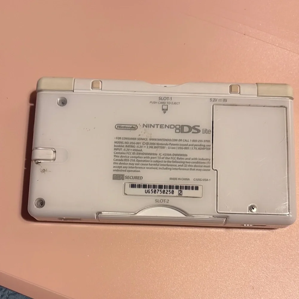 White Handheld Gaming Console with Pink Ribbon